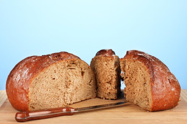 Sliced bread on blue background closeup