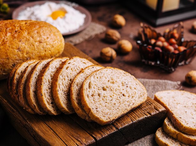 Sliced bread on board and flour with fresh egg