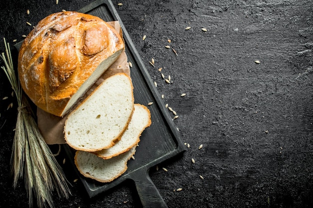 Sliced bread on a cutting Board with spikelets