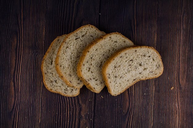 Sliced bread on a dark wood table