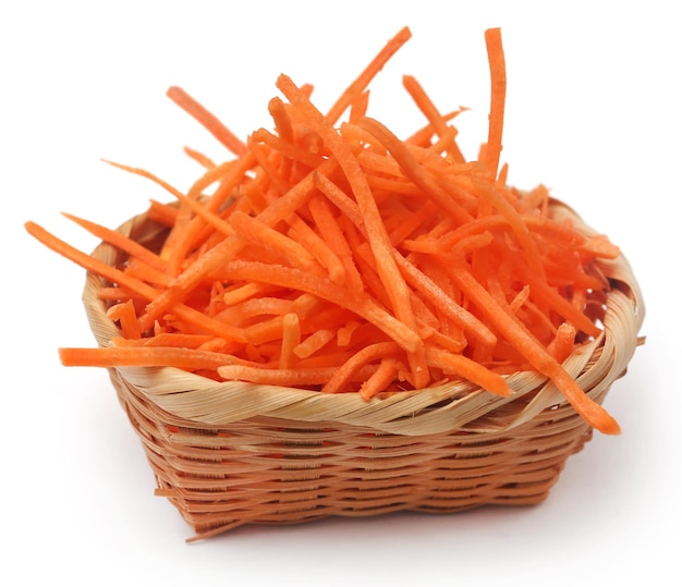 Sliced carrot in a basket over white background