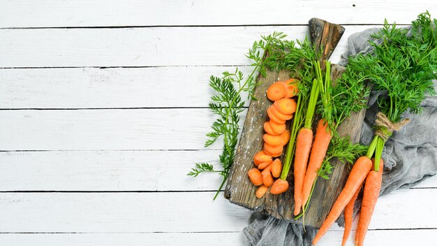 Sliced carrots on a wooden table Top view Free space for your text