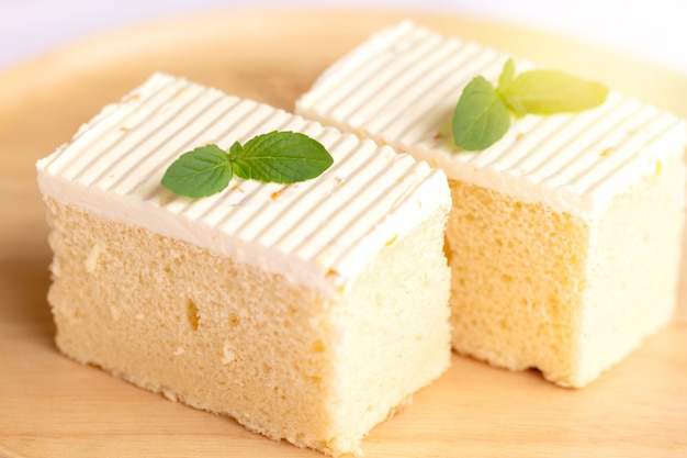 Sliced of cheesecake with mint leaves decorated on top.