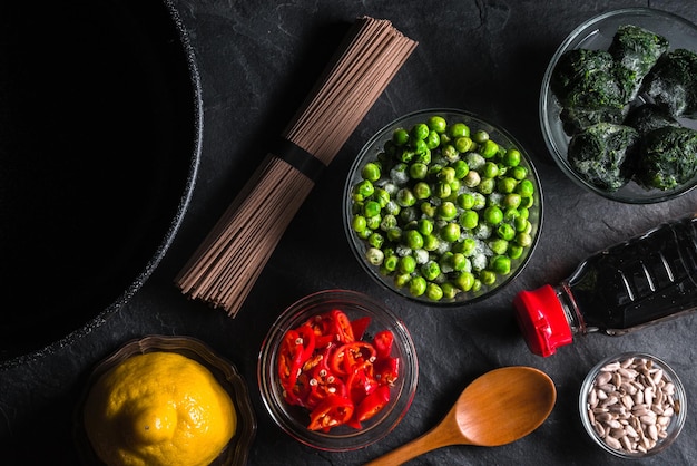 Sliced chili frozen peas in a bowl of buckwheat noodles