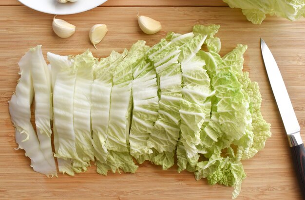 Sliced chinese cabbage on a bamboo chopping board