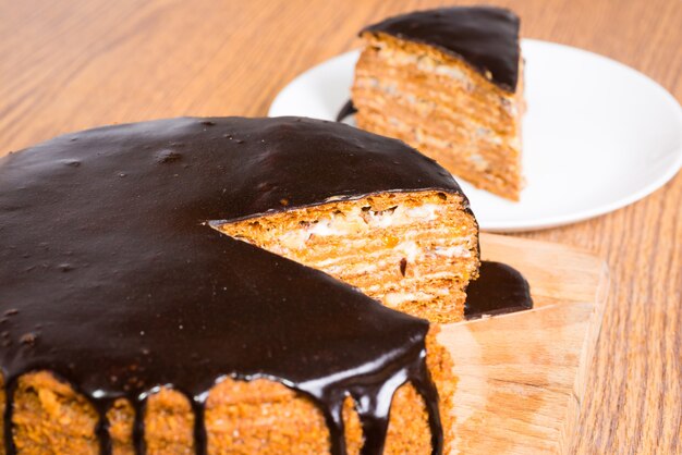 Sliced chocolate birthday cake on wooden table