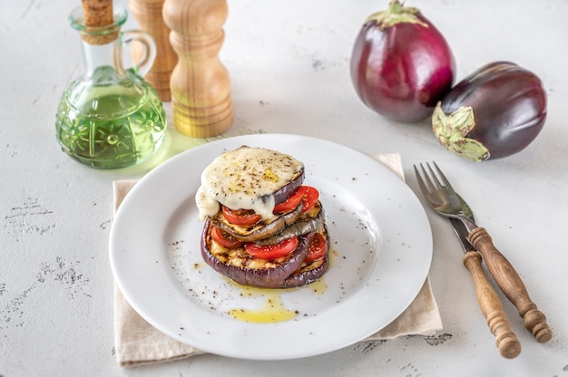 Sliced eggplant with cherry tomatoes and melted mozzarella