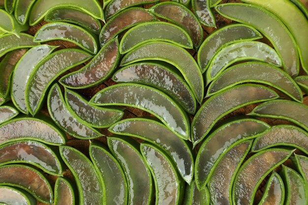 Sliced fresh aloe vera as background top view