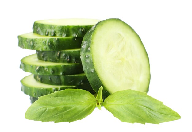 Sliced fresh cucumber with basil isolated on white