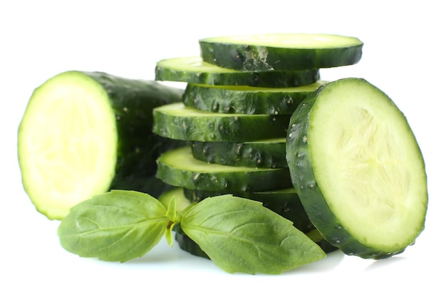 Sliced fresh cucumber with basil isolated on white