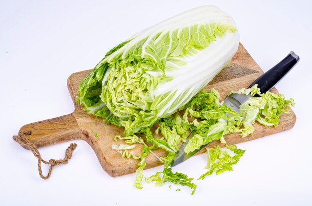 Sliced fresh green chinese cabbage on wooden cutting board. Studio Photo