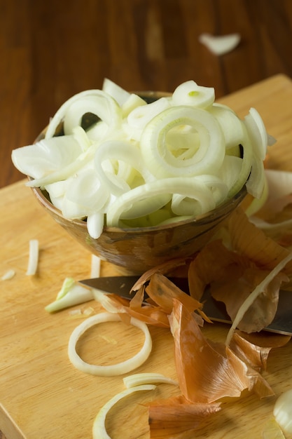 Sliced Fresh onion and Ripe onion on wooden background. Selective focus