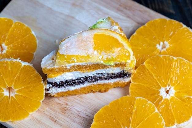 Sliced fresh oranges and a piece of orange dessert