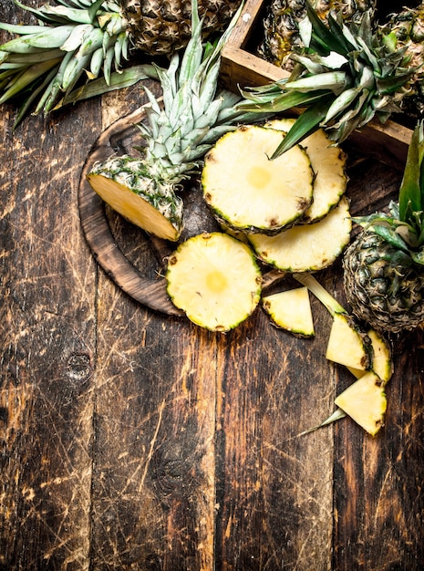 Sliced fresh pineapple on wooden table