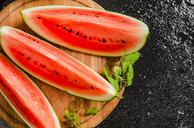 Sliced fresh watermelon on a black background