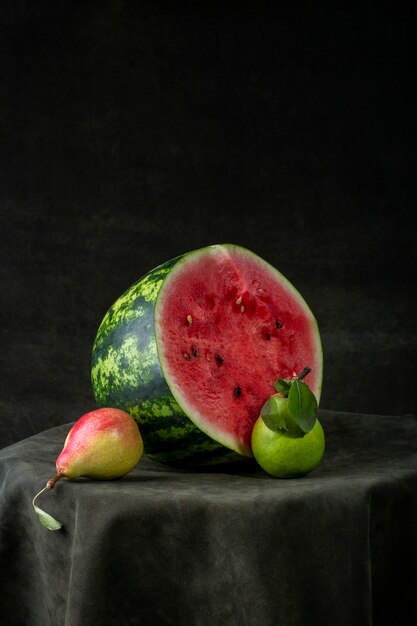 Sliced fresh watermelon on a round table with pears