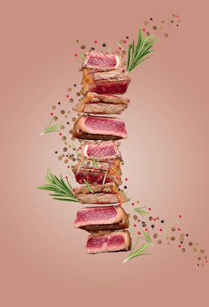 Sliced fried beef steak New York with spices and a sprig of rosemary degree of doneness rare