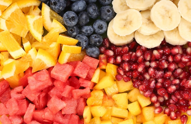 Sliced fruits on plate on wooden table