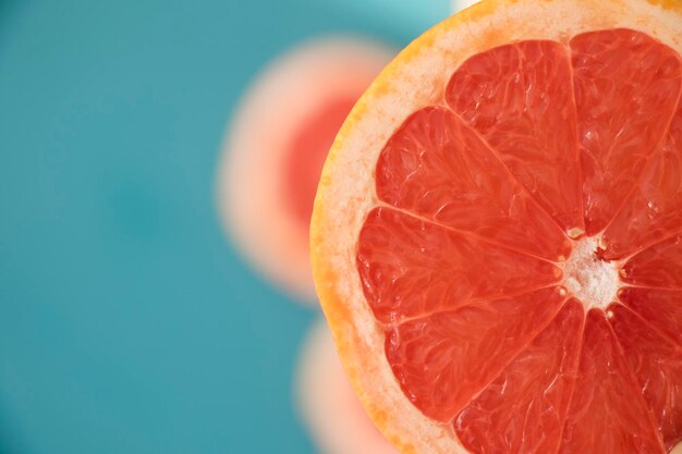 Sliced grapefruit on the blue background, cut grapefruit