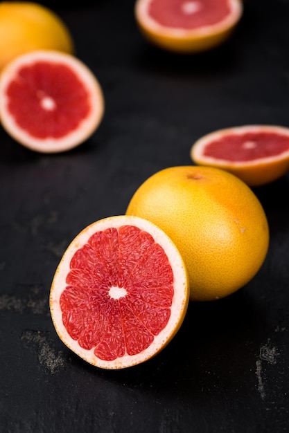 Sliced Grapefruits on a slate slab selective focus