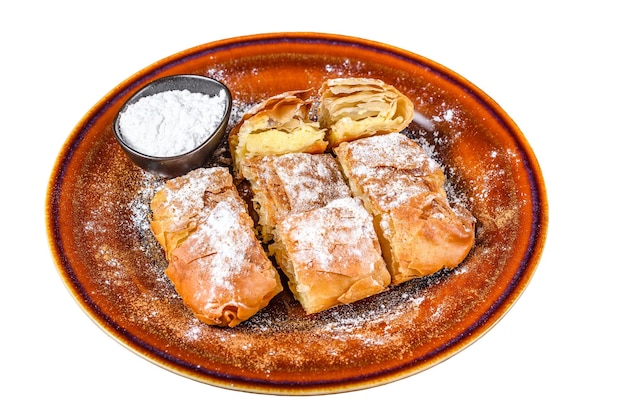 Sliced Greek Bougatsa pie with phyllo dough and semolina custard cream Isolated on white background