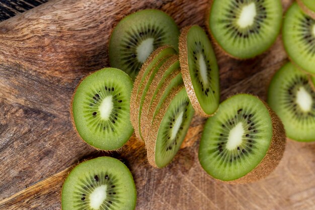 sliced green kiwi on a cutting board, sliced ripe green kiwi fruit