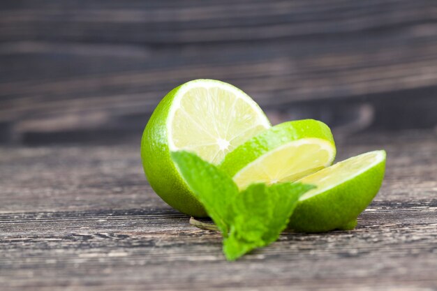 Sliced green lime with a mint leaf during cooking