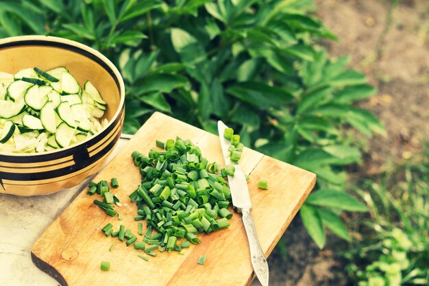 Cipolle verdi affettate e insalata con cetrioli e cavoli