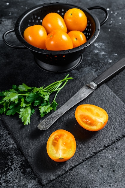 Sliced in half raw yellow cherry tomato. Top view