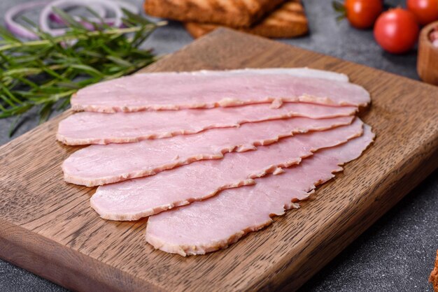 Sliced ham on wooden background Fresh prosciutto Pork ham sliced