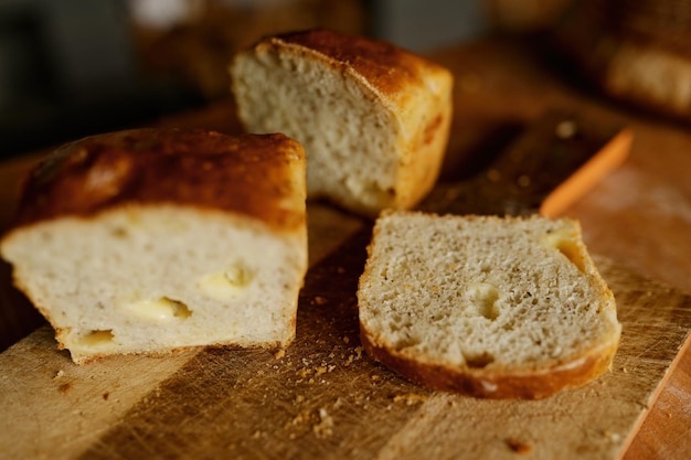 Sliced healthy wheat bread loaf on kitchen wooden board