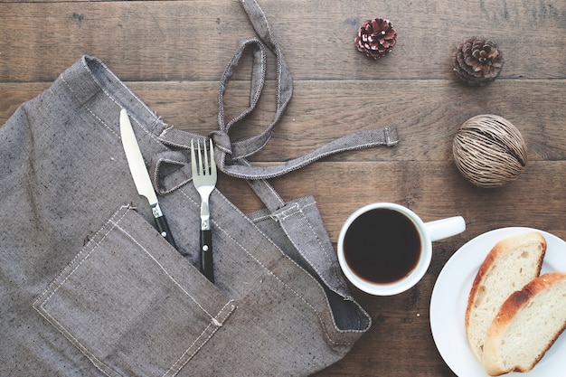 Sliced homemade bread with coffee on wood table with copy space