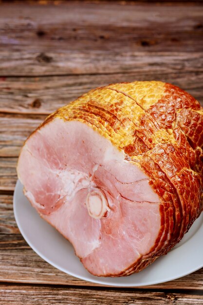 Sliced honey smoked ham on wooden table. copy space.