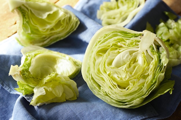 Sliced iceberg lettuce leaves on table