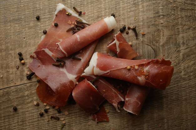 Sliced jamon on a wood background Parma ham jamon on wooden background with space for text