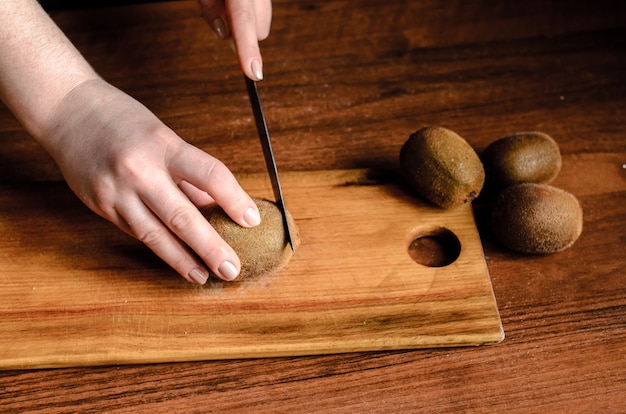 Sliced kiwi on a wooden board.