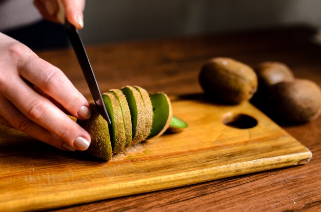 Sliced kiwi on a wooden board.