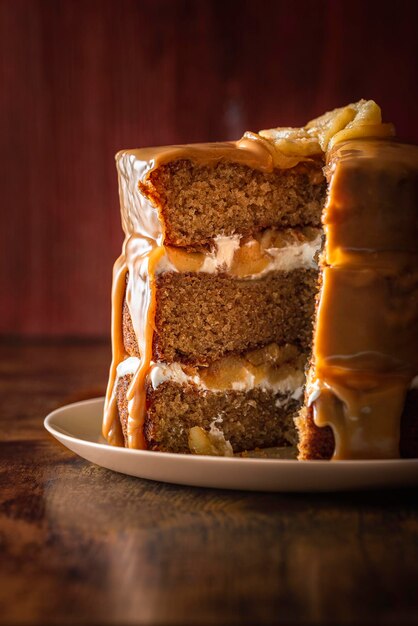 Sliced layered cake with cream and apple caramel cake interior