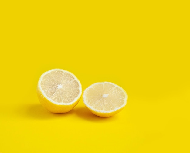 Sliced lemon on a bright yellow background