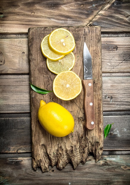 Sliced lemon on a cutting Board with a knife