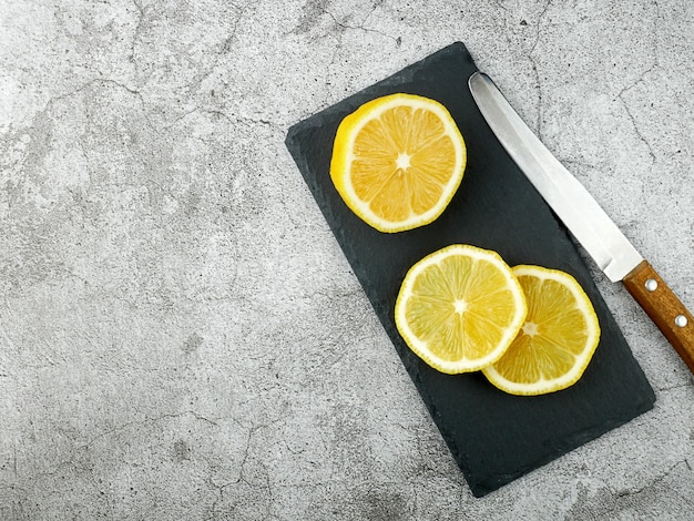 Sliced lemon lies on a stone board