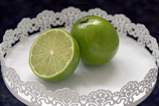 Sliced lemon on white tray on black granite