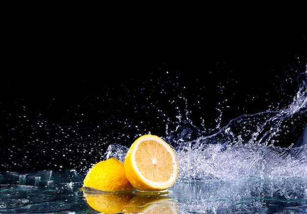 Sliced lemons in the water on black surface