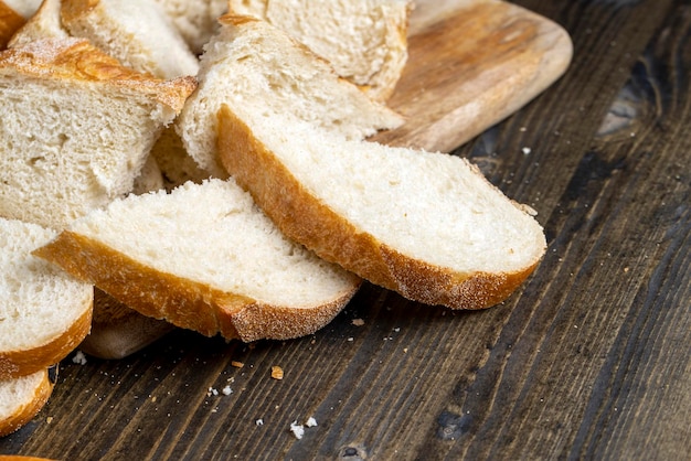 Sliced loaf of bread on a cutting wooden board