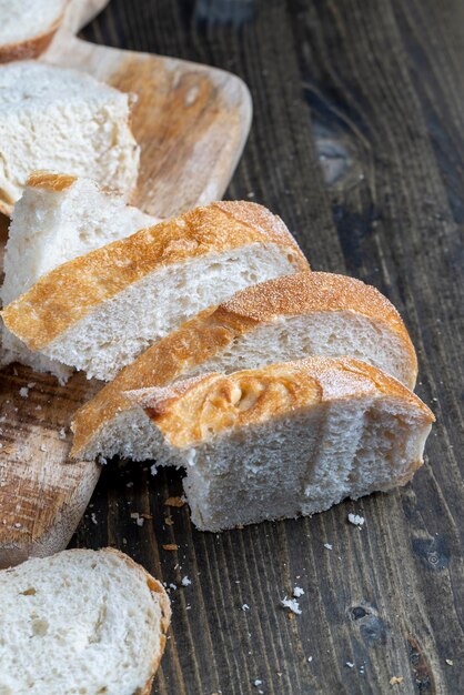 Sliced loaf of bread on a cutting wooden board