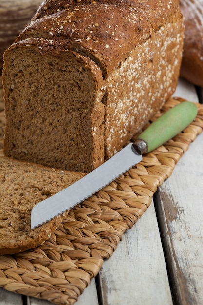 Sliced loaf of bread with knife