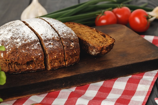 Sliced loaf of bread on wooden board