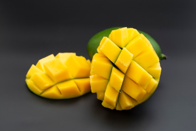 Sliced mango fruit isolated on a black background