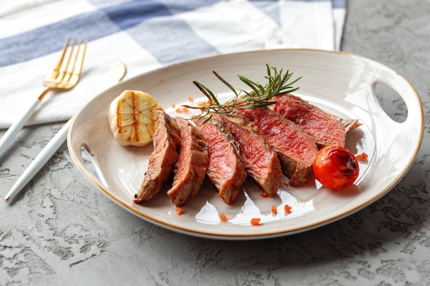 Sliced medium rare grilled steak on plate