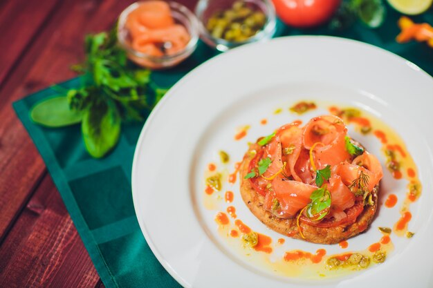 Sliced mushroom tart with cheese and tomatoes close-up on table. horizontal trout